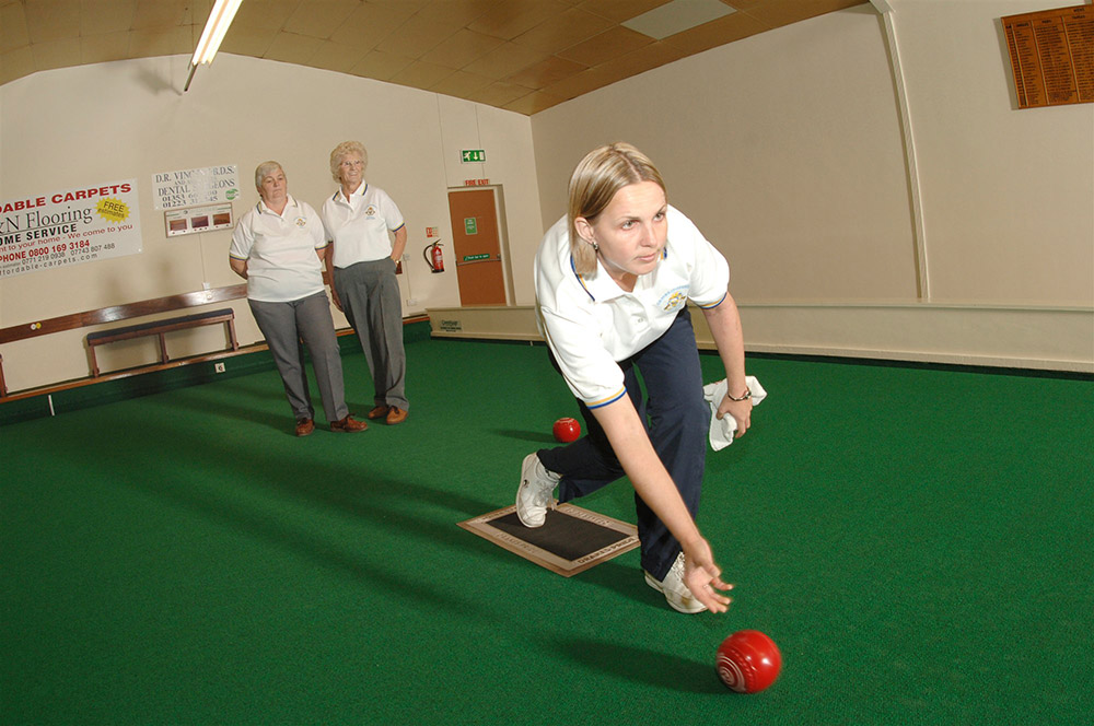 A lady playing bowls