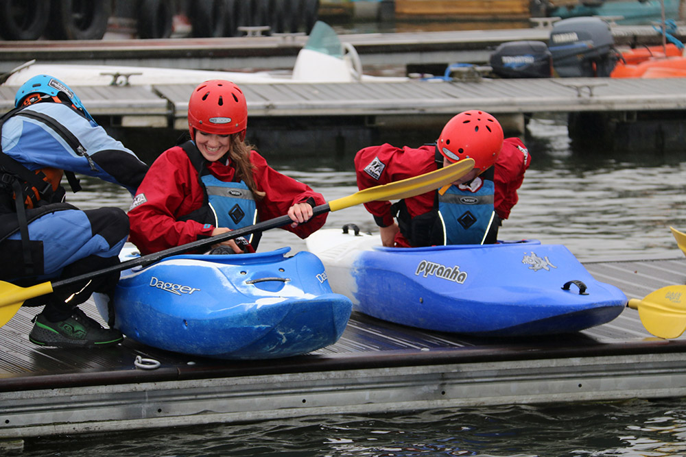 two women getting into canoe's