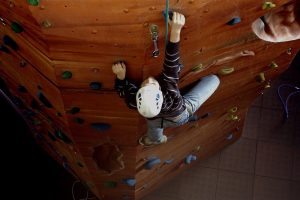 A boy climbing on a climbing wall