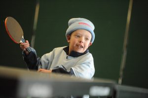 Young boy playing table tennis