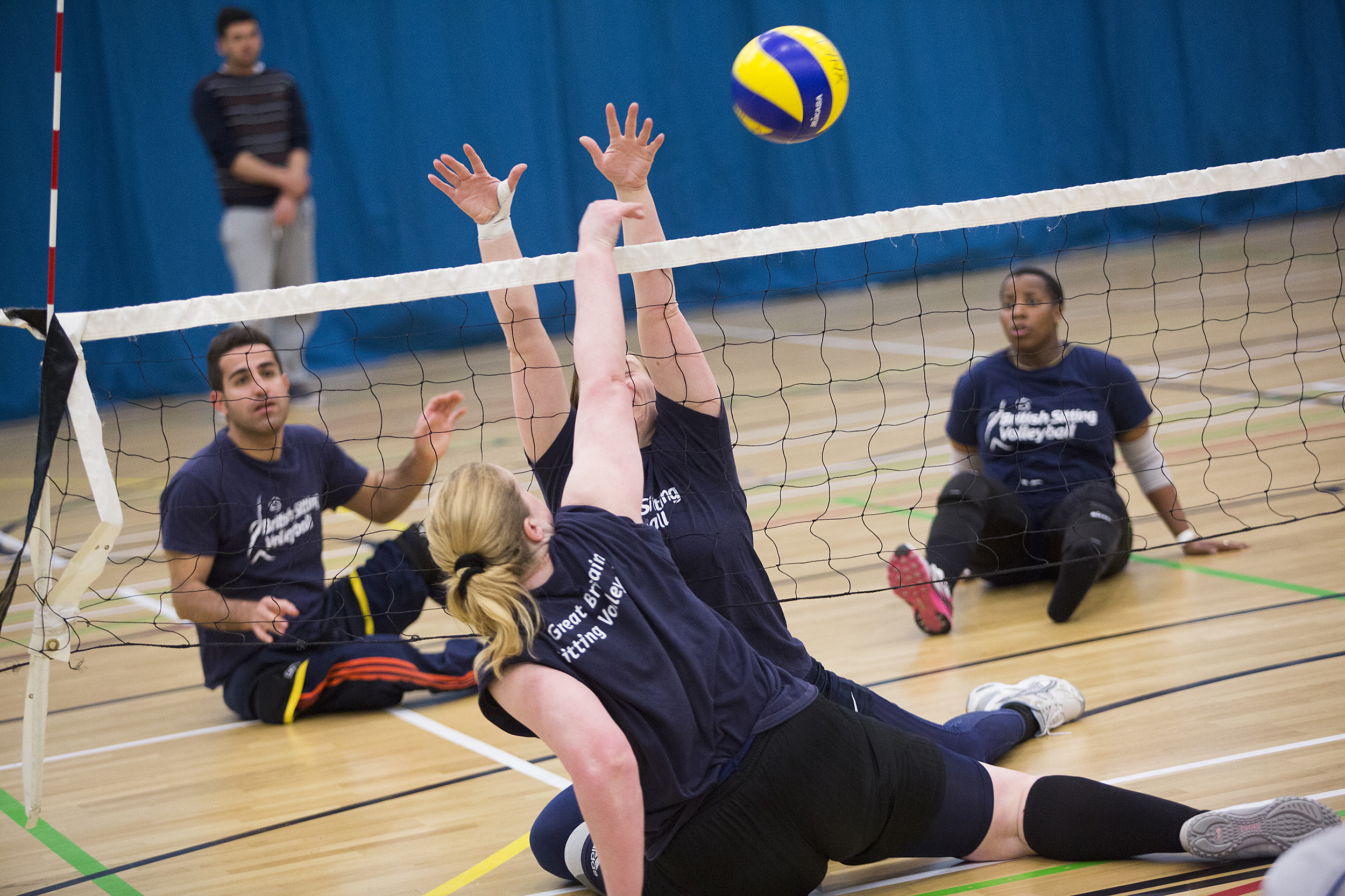 People playing sitting volley ball 