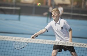 A boy playing tennis