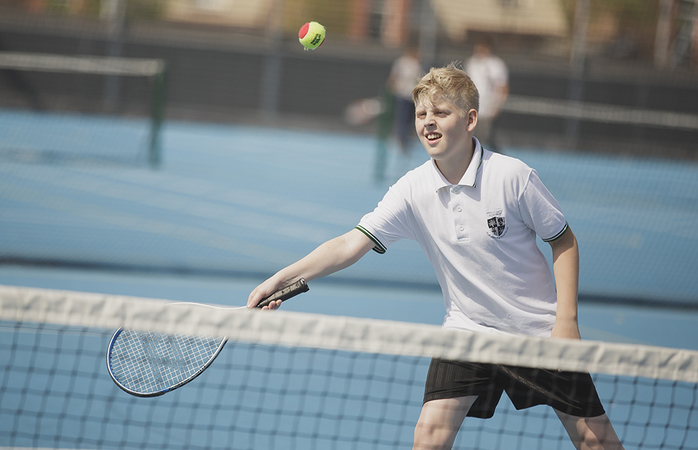 A boy playing tennis 